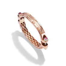 14k rose gold Coupling bracelet, angled view with pink sapphire cabochon bolt heads and warm gold lattice interior.   